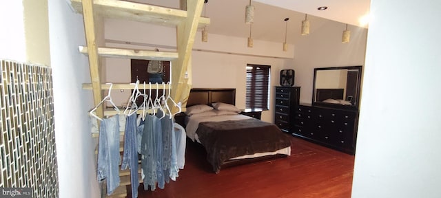 bedroom with dark hardwood / wood-style flooring