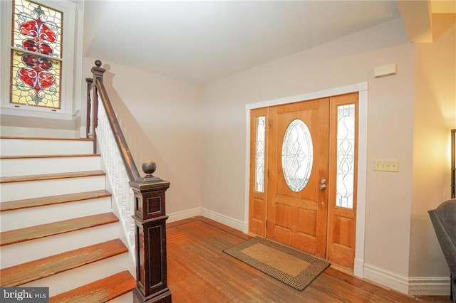 entrance foyer featuring plenty of natural light and hardwood / wood-style flooring