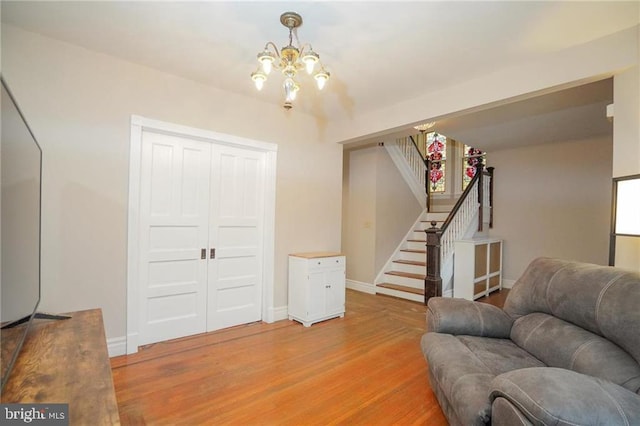 living room featuring a chandelier and light hardwood / wood-style floors