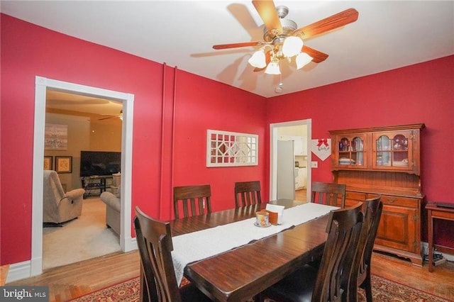 dining space with ceiling fan and hardwood / wood-style floors