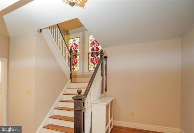 stairway with hardwood / wood-style flooring