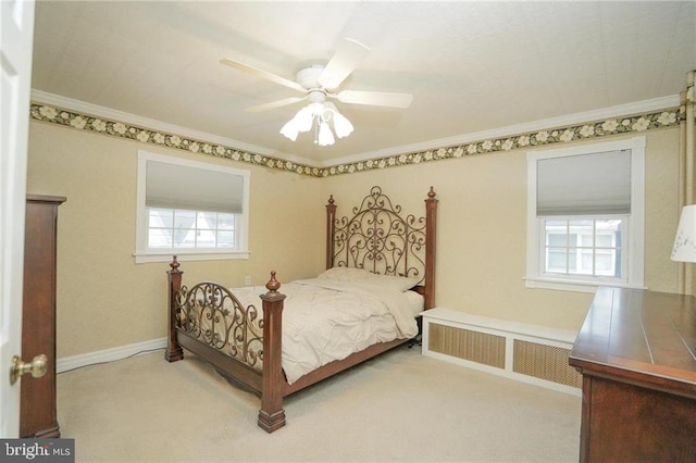 carpeted bedroom featuring ceiling fan, radiator, and crown molding