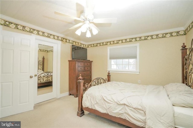 carpeted bedroom with ceiling fan and crown molding