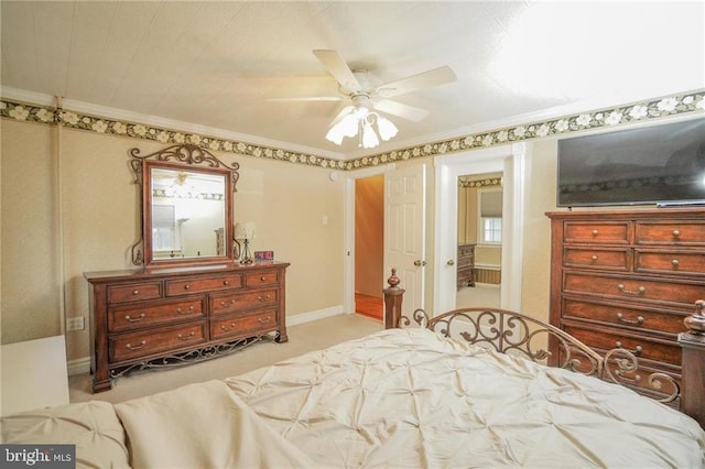 bedroom with ceiling fan, ornamental molding, and light carpet