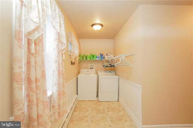 laundry area with baseboard heating and separate washer and dryer