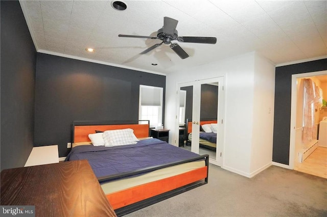 carpeted bedroom with ceiling fan, french doors, and ornamental molding