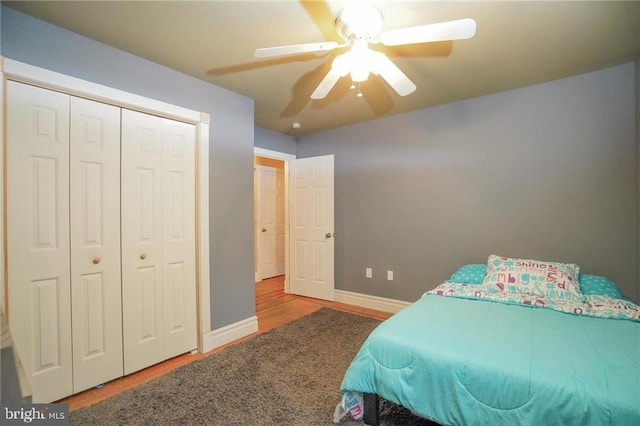 bedroom with ceiling fan and a closet