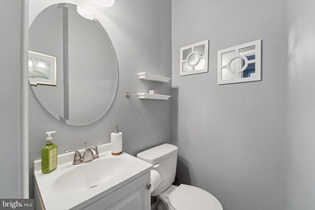 bathroom featuring toilet and vanity