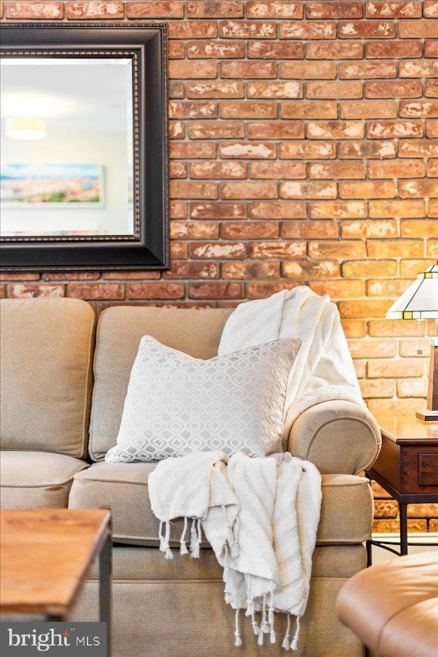 living room featuring brick wall