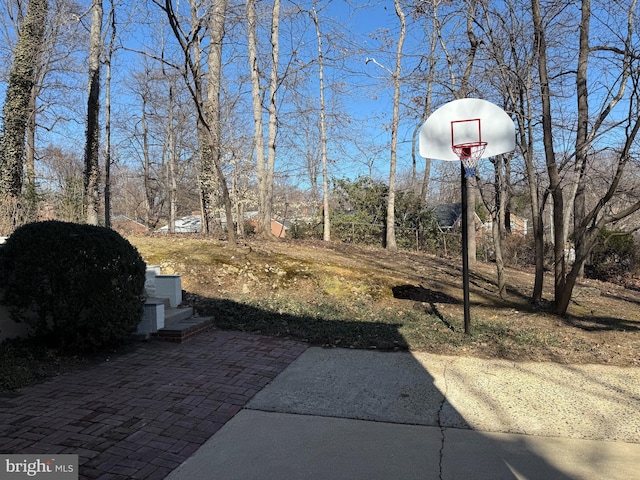 view of yard with basketball hoop