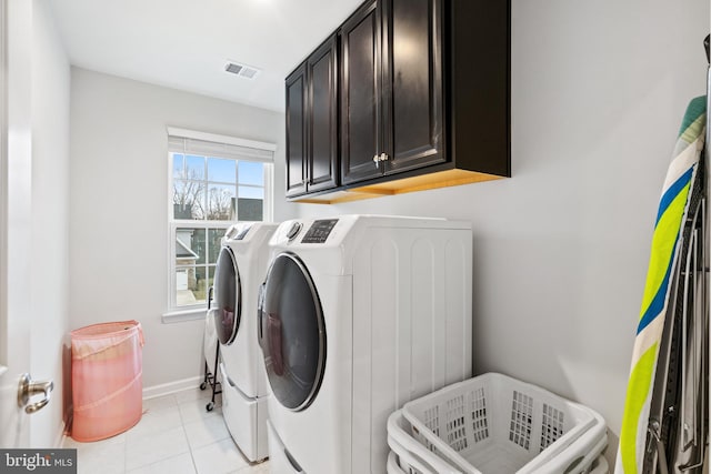 washroom with light tile patterned flooring, cabinets, and separate washer and dryer