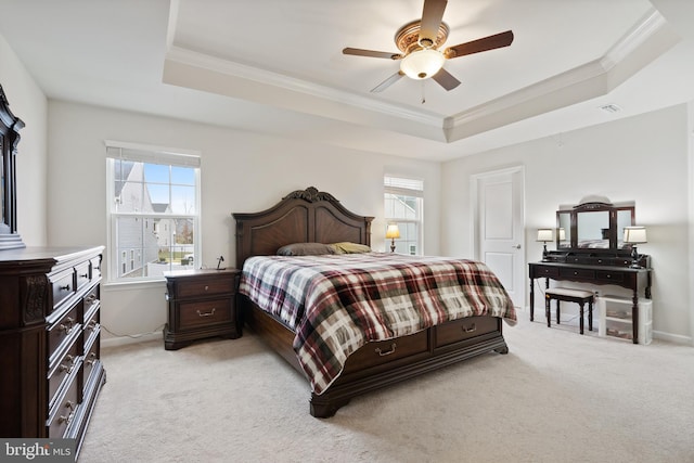 bedroom with a raised ceiling, ornamental molding, and light colored carpet