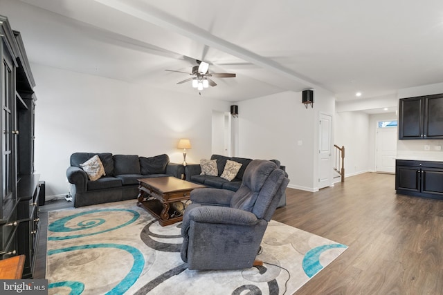 living room featuring wood-type flooring and ceiling fan