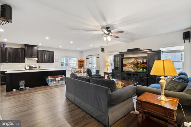 living room featuring hardwood / wood-style flooring and ceiling fan