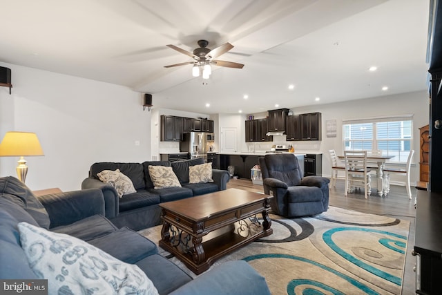 living room featuring hardwood / wood-style floors and ceiling fan