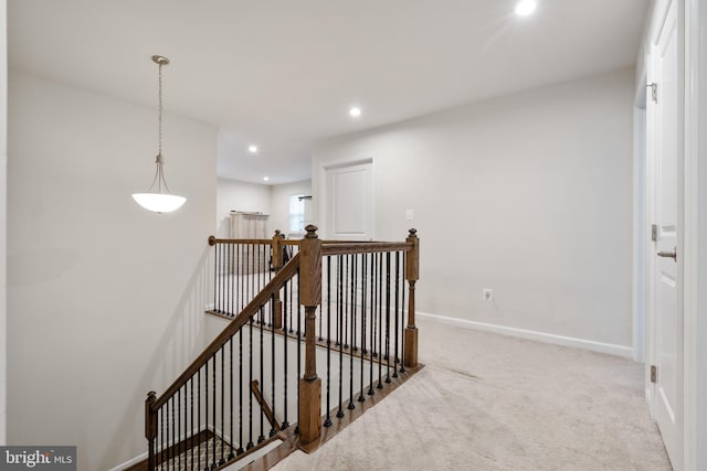 corridor featuring light colored carpet