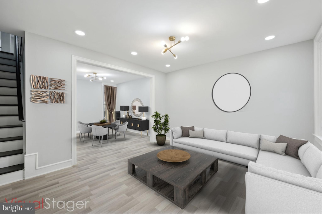 living room with a chandelier and light wood-type flooring