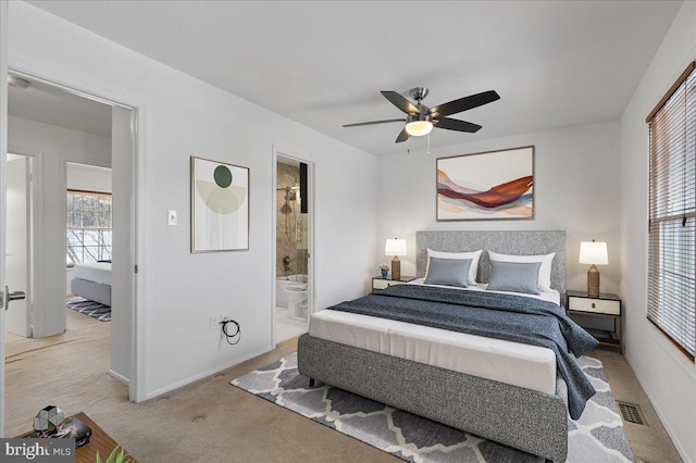 carpeted bedroom featuring ceiling fan and ensuite bathroom