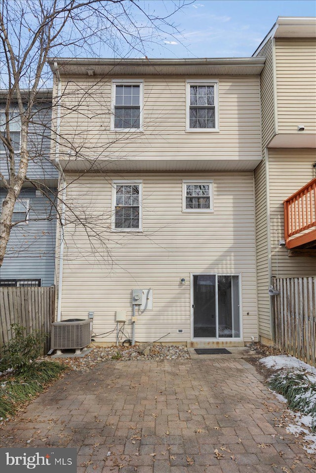 rear view of property with a patio and central AC unit