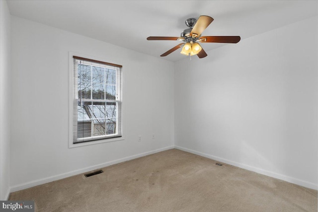 carpeted empty room featuring ceiling fan