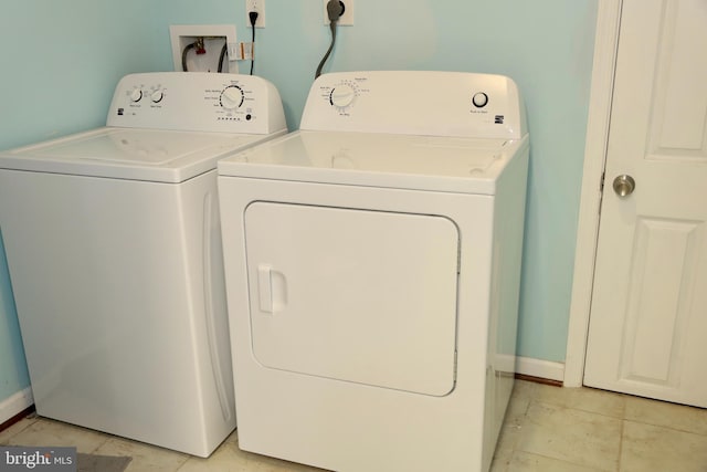 washroom featuring separate washer and dryer and light tile patterned floors