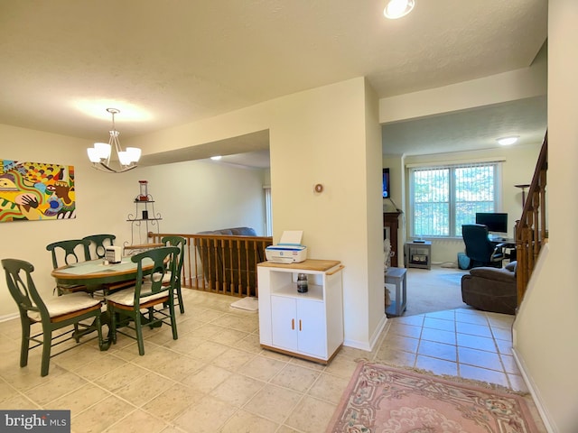 dining room with light tile patterned floors and a chandelier