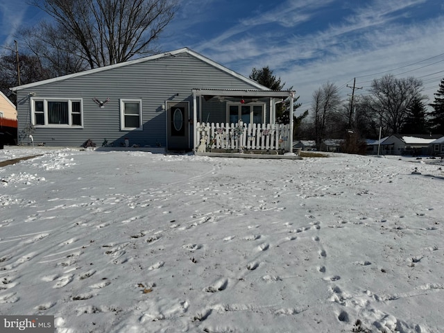 snow covered house with a porch