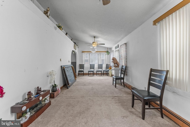 interior space featuring light carpet, ceiling fan, a textured ceiling, and lofted ceiling