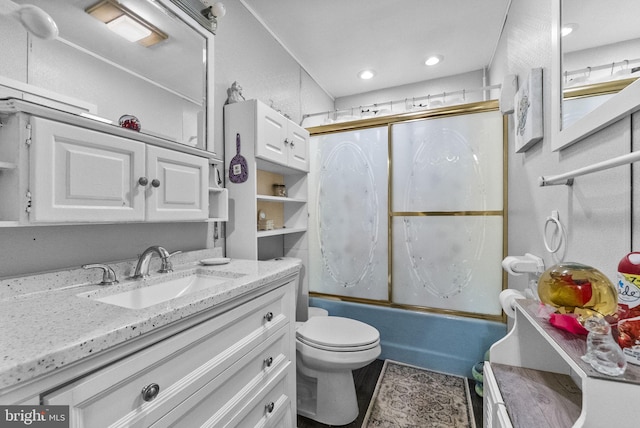 full bathroom featuring toilet, combined bath / shower with glass door, vanity, and recessed lighting