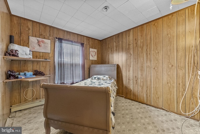 carpeted bedroom with wooden walls