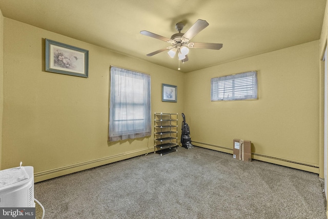 carpeted empty room with ceiling fan, a baseboard heating unit, and baseboard heating