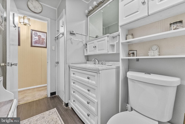 bathroom with vanity, wood finished floors, and toilet