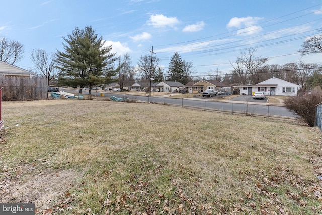 view of yard with a residential view and fence