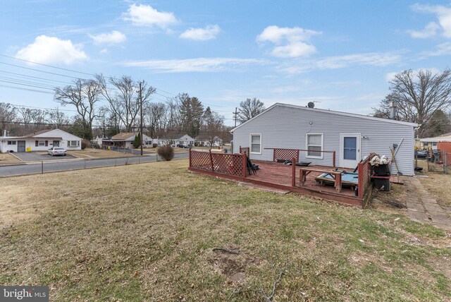 view of yard featuring a wooden deck and a residential view