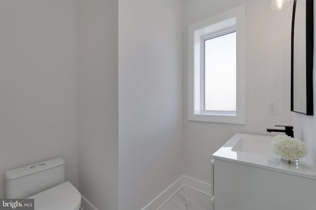 bathroom featuring toilet and vanity