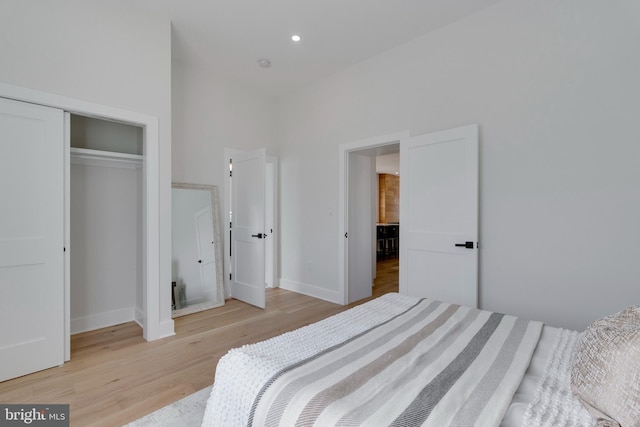 bedroom featuring a closet and light hardwood / wood-style flooring