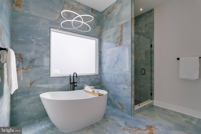 bathroom featuring tile walls and plus walk in shower