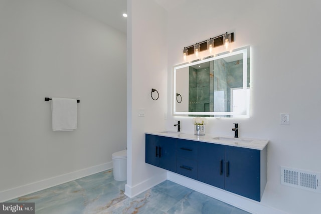 bathroom featuring vanity and toilet