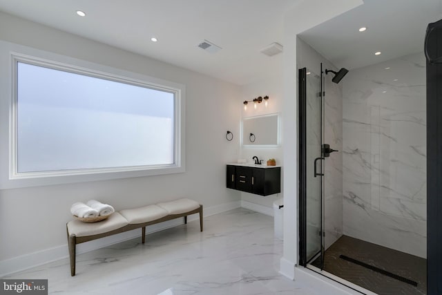 bathroom featuring a shower with shower door and vanity