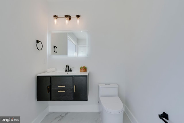 bathroom with toilet and vanity