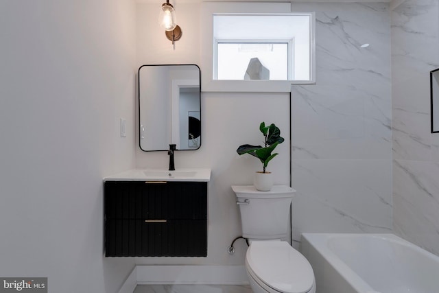 bathroom featuring a washtub, toilet, and vanity