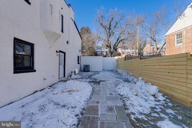 yard layered in snow with central AC