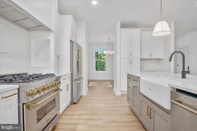 kitchen with white cabinetry, hanging light fixtures, custom exhaust hood, and high quality appliances