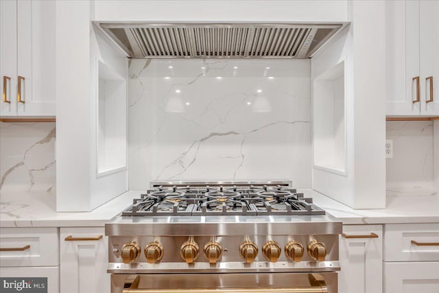 kitchen with decorative backsplash, white cabinets, ventilation hood, and stainless steel range oven