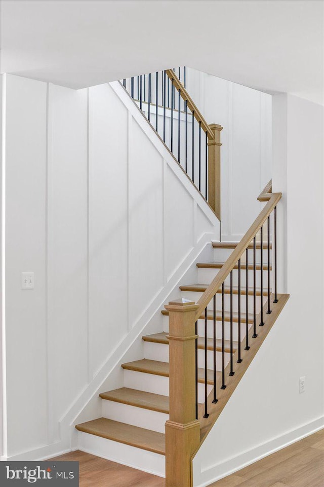 staircase featuring wood-type flooring