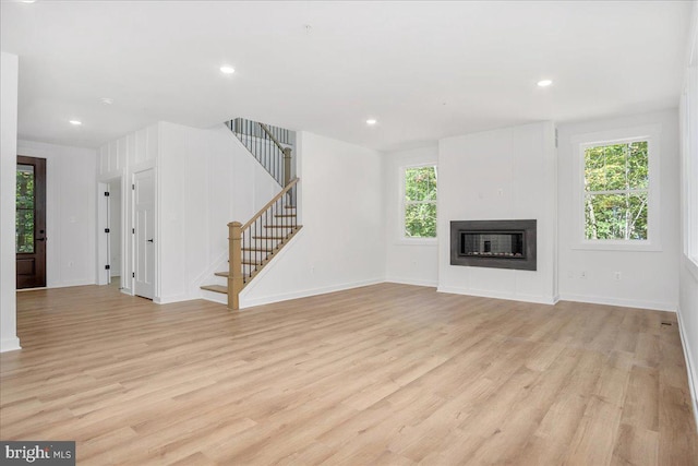 unfurnished living room with light hardwood / wood-style flooring