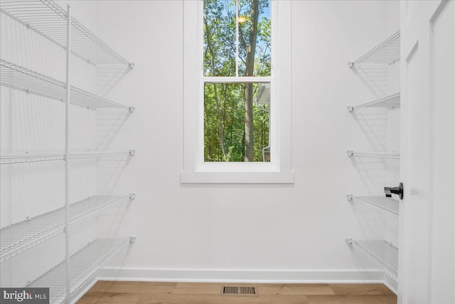 spacious closet featuring hardwood / wood-style floors