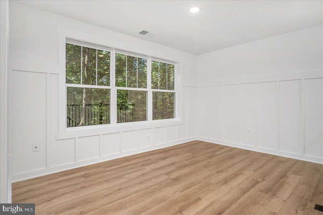 spare room featuring light wood-type flooring