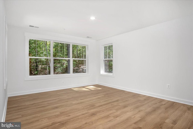 empty room with light hardwood / wood-style floors