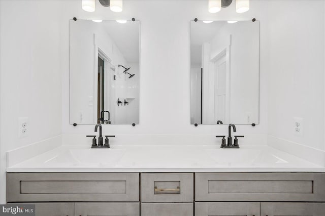 bathroom featuring vanity and a shower with door